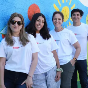 4 people in white t-shirts leaning against a mural