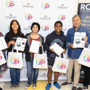 Six people posed with matching bags.