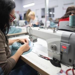 apparel factory worker at sewing machine