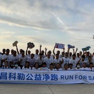A large group outside behind a banner "Run for safe water."