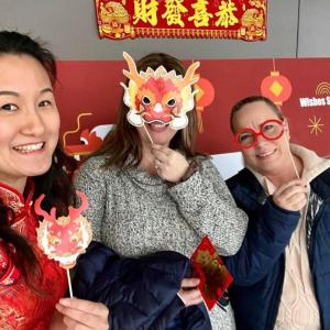Three people holding up masks