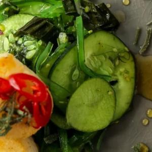 Close up of plate of scallops, greens and honeycomb