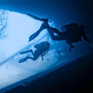 Two scuba divers in an underwater structure