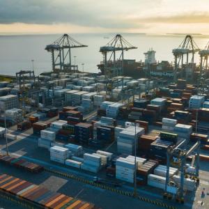 Aerial view of containers at a port by the ocean