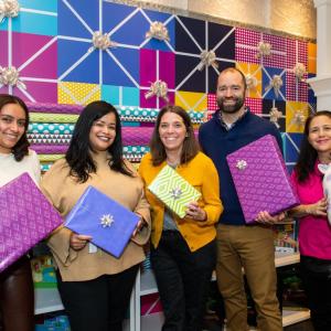 Group holding wrapped gifts