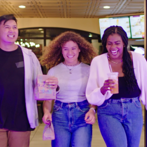 Three people laughing and walking together