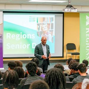 Someone talking in front of a seated group