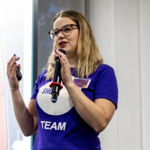 Kate Kirwin speaking with a microphone.