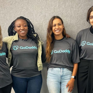 four women wearing the same "GoDaddy" shirt