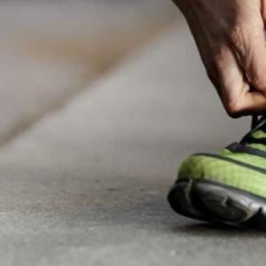 person tying their shoe