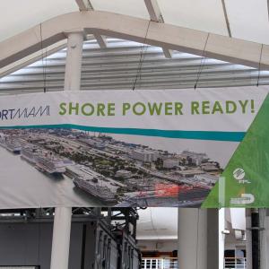 A banner hung from steel rafters "PortMiami Shore Power Ready".