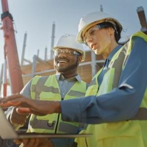 Builders on site working from laptop