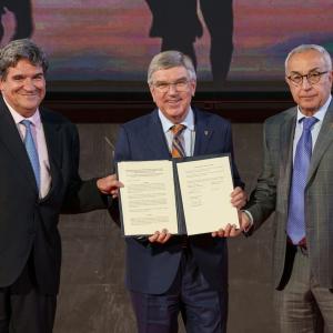 three people hold official signed documents