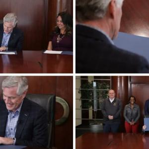 Collage of four photos of the CEO seated, signing a document at a large wood desk. A group of 5 people behind them.