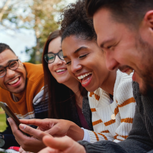 People outside smiling at their phone