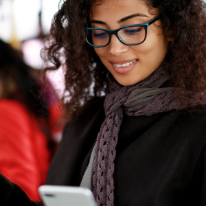 smiling woman on her phone on public transportation
