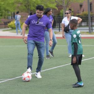 player and coach playing soccer