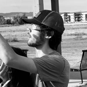 A black and white photo of two people watching an eclipse.