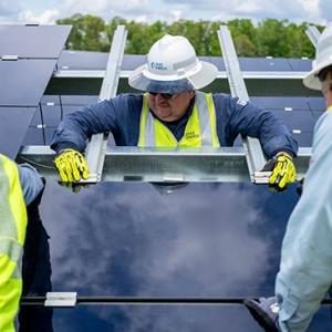 Duke Energy employees installing solar panels