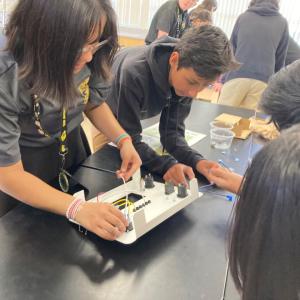 A team of students working on solar battery kit.