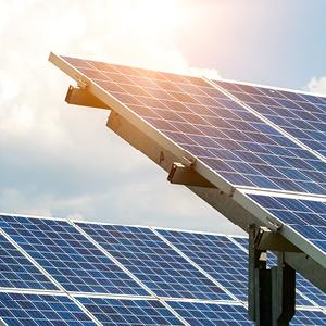 Solar panels with a sun behind them.