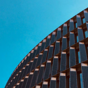 a huge solar panel lined structure, a blue background