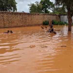 Children play in a pool of water in Baidoa. During the heavy rains, cholera and water borne diseases are common and risk the lives of vulnerable families.