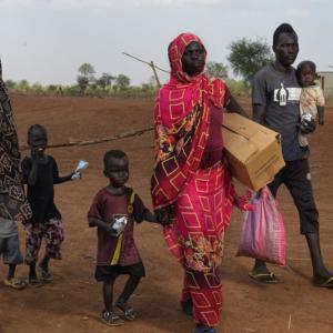 A displaced family crosses the border into South Sudan. / Photo by Peter Caton