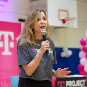 A person speaking in to a microphone 