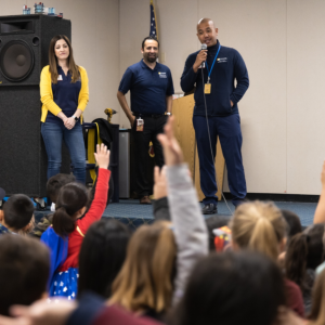 SCE volunteers on stage talking to students