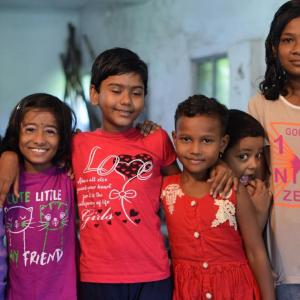 A group of kids with arms around each other.