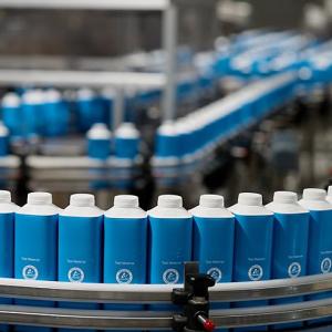 A conveyor line of beverage containers.