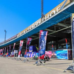 Banners for race care drivers on a track.