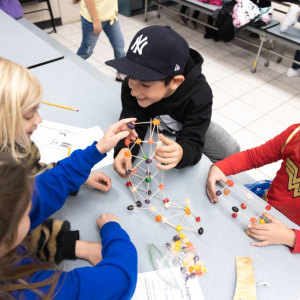 Kids building a tower with toothpicks and jelly beans