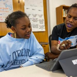 A teacher working with a student