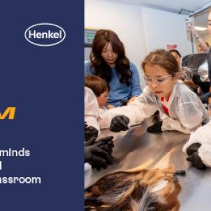 "Breaking Stigmas about STEM" Henkel logo and children dressed in lab protective gear surrounding a table