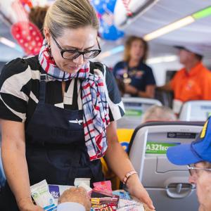 Person serves food to a passenger