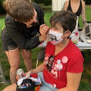 Person having makeup done by another