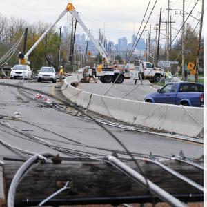 Electrical lines down on a highway with text "Strength in Service"