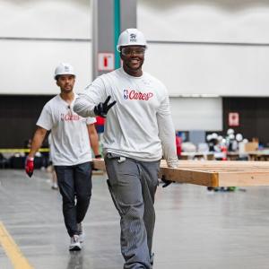 volunteers carrying things and smiling