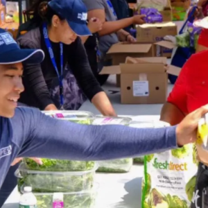 Someone handing food to someone
