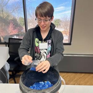 Student fills a sample bag.