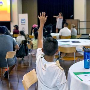 student raising their hand