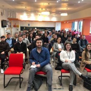 A room full of seated students and staff.
