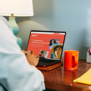 a person working at a desk on a laptop