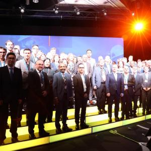 Suncor employees standing on a stage, wearing medals