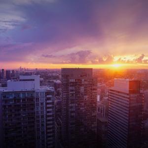 Sunsetting in the distance. A city landscape in front.