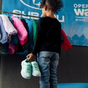 child looking at new clothes