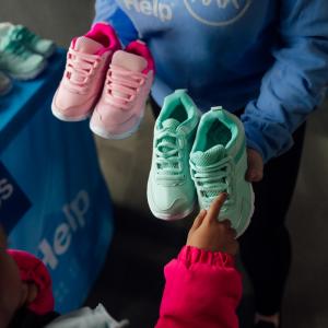 people holding children's shoes