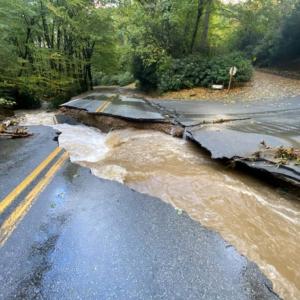 Flooding running through a broken road